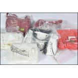 A collection of ladies leather handbags to include white and red examples,