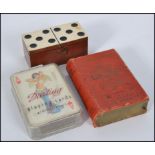 A great set of 1950's saucy playing cards, a bone and wood miniature dominoes set in case,