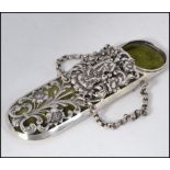 A continental silver spectacles case having pierced foliate case with velour lined interior having