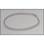 A ladies contemporary silver line set cz bracelet / bangle.