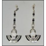 A pair of silver and onyx marcasite art deco style drop earrings, each of half roundel form.