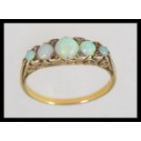 An early 20th century tested 9ct gold and opal ring set on a gypsy setting with plain shank having