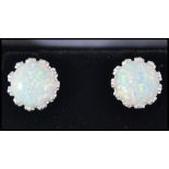 A pair of silver and opal adorned ladies contemporary earrings - ear studs complete in the