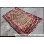 An early 20th century handwoven Islamic / Persian Isfahan rug having an unusual beige centre with