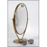 A retro brass swing double sided shaving mirror along with a pair of mid century style sun glasses
