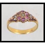 A Victorian tested 18ct gold pearl and amethyst set ladies ring set on decorative shank. Mark worn.