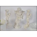 A collection of china to include a cherub figurine and cherub candlesticks etc.