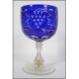 A 20th century over sized etched and cut glass goblet of Bohemian / Bristol blue style.