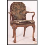 A 19th century mahogany open framed armchair being raised on claw and ball feet with cabriole legs