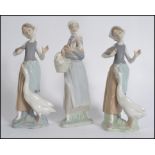 A collection of three Lladro porcelain figurines,