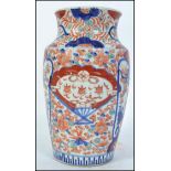 A Chinese famille rose / Imari vase having decorative panel scenes with waisted neck and character