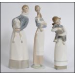 A collection of three Lladro porcelain figurines of young girls with animals,