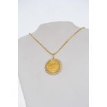 A 14ct gold chain with 18ct gold Olympic Munchen summer games 1972 ( munich) coin medal pendant.