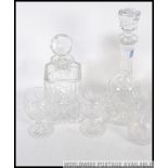 Two 20th century cut glass decanters with stoppers along with a set of four matching cut glass