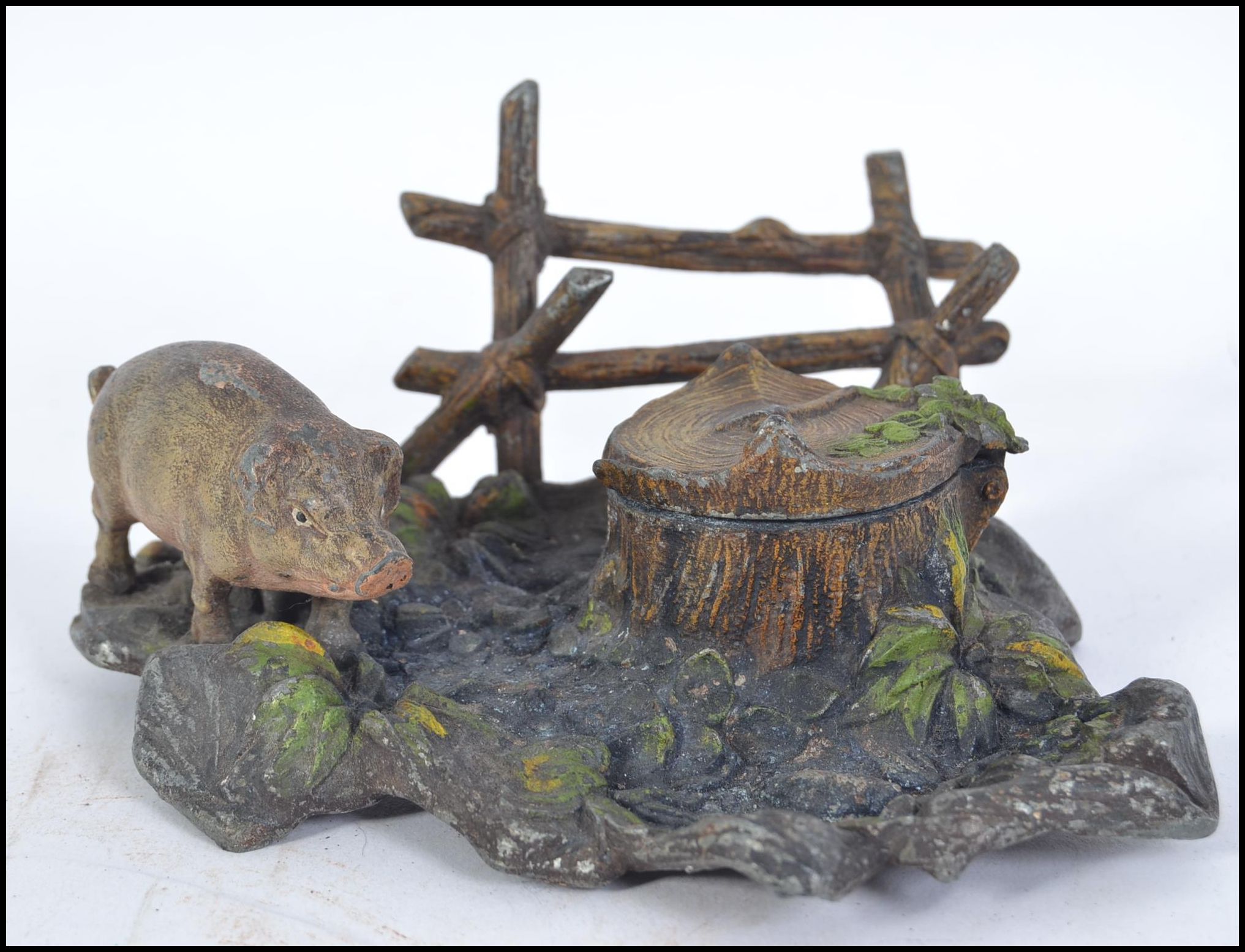 A fabulous cold painted spelter pig and tree stump inkwell cast in the form of a naturalistic