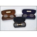 A set of 3 vintage gentlemans spectacles each with the cases and testing for 9ct gold.