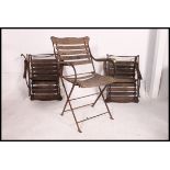 A set of 3 early 20th century folding garden teak and wrought iron garden chairs.