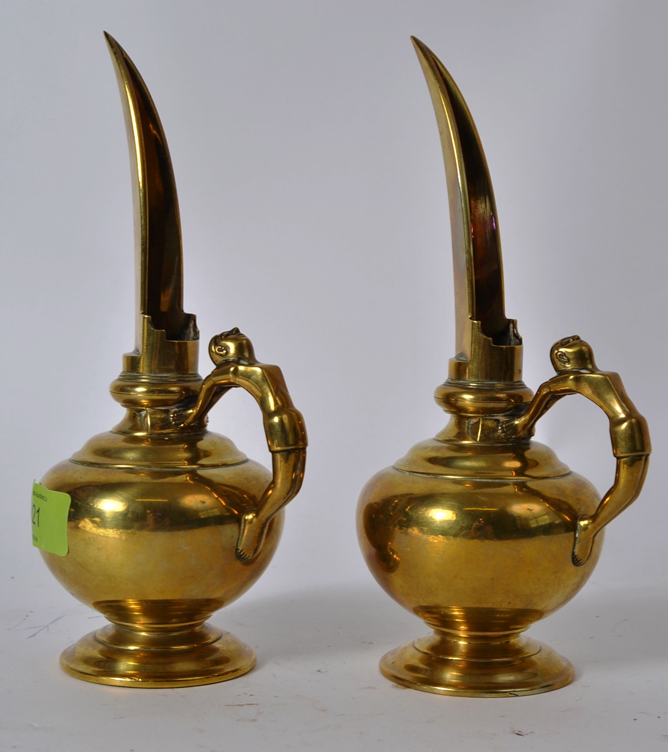 A pair of late 18th / early 19th century Indian long spouted temple oil ewers with anthropomorphic