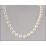 A fine cultured pearl necklace, circa 20th century having gilded silver finial ball clasp.