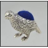 A 20th century silver pin cushion in the form of a partridge / game bird having inset cushion top.