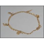 A hallmarked 9ct gold charm bracelet with daolphin coffee bean heart and horn of plenty four leaf