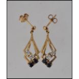 A pair of 9ct gold sapphire and diamond ladies earrings hallmarked to the stud.