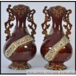 A pair of 19th century bargeware style Majolica vases being stone glazed with embellishments H37cm