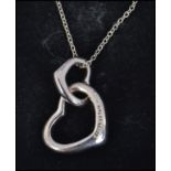 A silver ladies contemporary 925 interlocked heart pendant and necklace chain complete in the box.