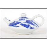 A Chinese blue and white yi-xing teapot in the Kang-xi style complete with the lid having blue