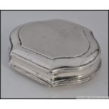 An unmarked Georgian silver snuff box of scalloped form with later 19th century engravings.