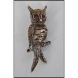 A decorative vintage ladies costume jewellery brooch in the form of an owl upon a branch