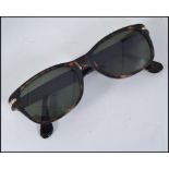 A pair of original Giorgio Armani sunglasses with monogram etching to the lenses complete in the