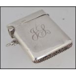 A silver hallmarked vesta case with monogram to centre.