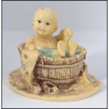 An unusual Chinese Okimono type figurine / diorama of a child in a bath H8cm