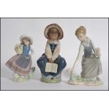 A collection of three Lladro porcelain figures to include a Lladro Daisa figure of a young girl