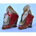 A pair of Chinese red silk and embroidered shoes with laces being handstitched,