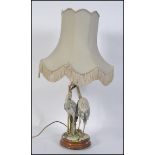 A 20th century Capodimonte table lamp depicting a pair of storks / Herons on a naturalistic base