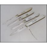 A collection of 4 silver mother of pearl hallmarked fruit knives - pen knives.