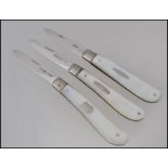 A collection of 3 silver mother of pearl hallmarked fruit knives - pen knives each with plain