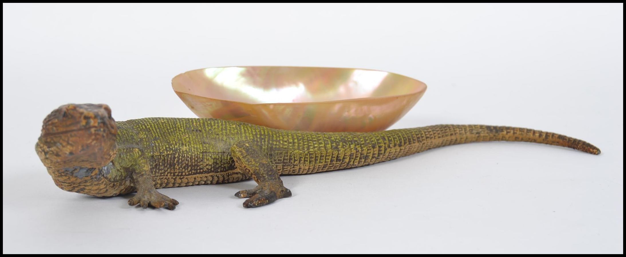 A stunning early 20th Century cast metal cold painted model of a lizard,