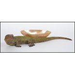 A stunning early 20th Century cast metal cold painted model of a lizard,