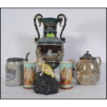 A collection of ceramics to include a twin handled bulbous vase raised in relief,