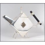 A silver plated teapot in the manner of Christopher Dresser having angular form, pierced centre.