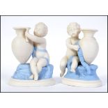 A pair of early Royal Worcester white glazed figural candle sticks.