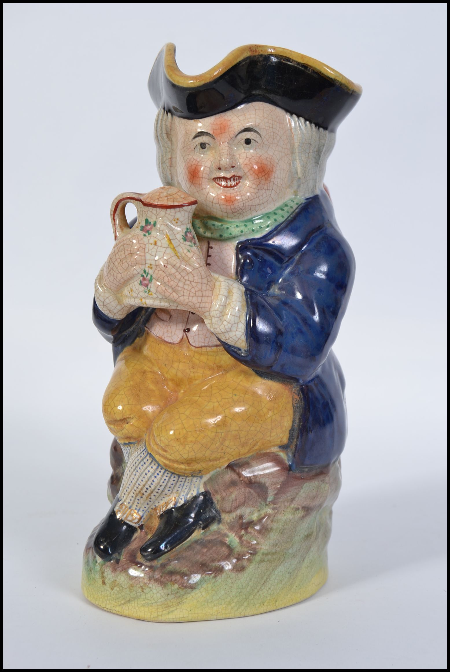 A 19th century Staffordshire Ralph Wood-type Toby jug in the form of a seated Toby Fillpot holding