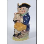 A 19th century Staffordshire Ralph Wood-type Toby jug in the form of a seated Toby Fillpot holding
