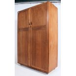 A stunning light beech and elm wood Ercol two door ' Windsor pattern ' wardrobe,