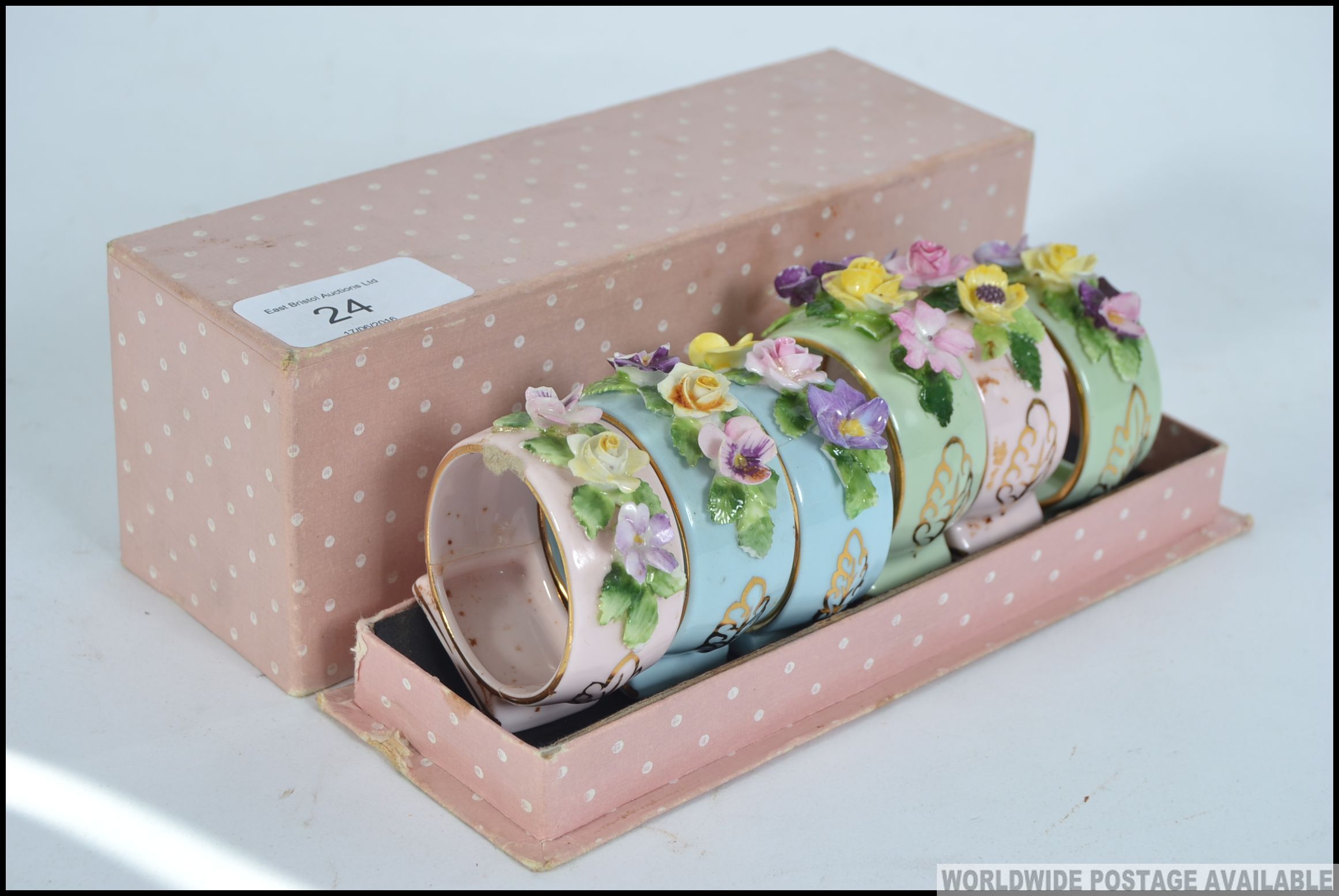 A cased set of mid century ceramic napkin rings embellished with floral sprays complete in the