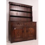 A good quality Jacobean revival oak dresser in the manner of Old Charm.