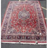 A early 20th century Kashan - Iranian style rug / carpet with deep red ground interspersed with